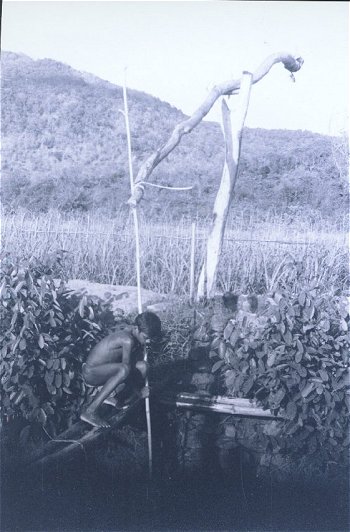 Boy Lifting Water for Irrigation