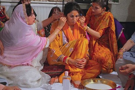 Bride goes through ceremony called Chura and Maiya