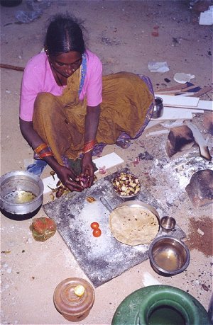 Homeless Woman Cooking on the Street