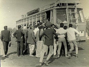 People Rushing to Get on to a Local Bus