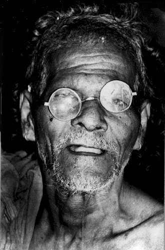 Elderly Indian with broken eye glasses