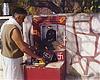 A Devotee Offers Prayers at a Tiny, Roadside Temple