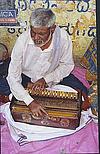 A Blind Man Playing the Harmonium