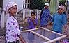 Girls Filtering Sand