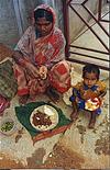 Mother Feeds Child and Self During Lunch Break