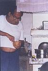 Kamat Grating a Coconut