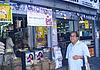 Kamat in front of a grocery store