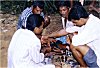 Men Feeding Alcohol to a Rooster