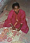 Girl Making Garlands for Sale