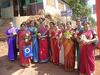 Women in Silk Sarees and Welcome Bouquets