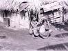 Tribal Women in front of their Hut