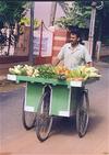 Man Wheeling Vegetables Door-to-Door