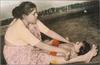 Mother Attends to Child -- Jyotsna with Vikas, 1967