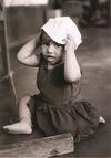 An Infant Tries on a Gandhi Cap