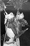 Decorated Tribal Dancers Using Firelogs to Light Cigarettes, Madhya Pradesh