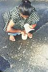 a girl drawing rangoli