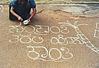 a girl drawing rangoli