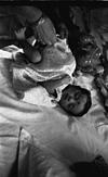 baby aparna on bed with her play things