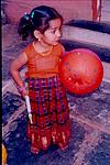 A kid with bat and balloon