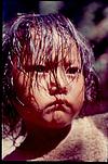 A child peeping through the screen of his hair