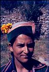 A Himalayan young lady with a flower in her cap