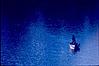 A lone boat man on a Himalayan lake