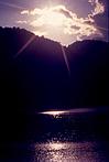 Rising sun beam on a lake
