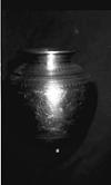 A metal jar with carving