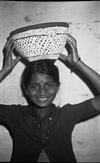 A hand woven basket being carried to field