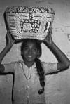 A young girl carrying the painted basket