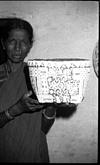 A woman exhibiting a painted basket