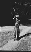 A woman carrying basket to the field