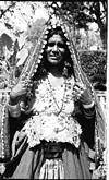 A proudly exhibiting her hood with coins