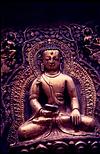 A metal statue of Meditating Buddha