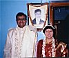 Newly Weds in front of an ancestor's Photo