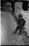 A child in woolen playing in snow