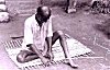 Man Waeving a Carpet from Bamboo strips