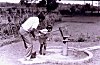 A Father and Son Quench Thirst at a Roadside Well