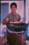 A boy frying Pakodas at road side eatery