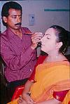 A dancer getting a final touch from the makeup wala