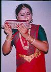 A young dancer salutes her foot-bells before putting it on. There is Divinity in all the dance tools as per belief of the dancers