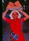A women builder carrying bricks on the head