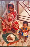 A young builder at her curdle meal of rotis and vegetables.