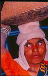 A woman laborer carrying sand