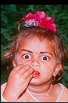 Baby eating tomato