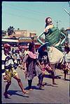 Masked female dancer in procession, Kannada sahitya sammelana, Honnawar, 1997