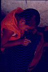 A Tibetan boy, writing on a tablet, Tibetan monastery, Mundugod, 1983