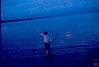 A lady fishing with her net at lake, 1964
