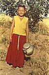 Tibetan boy goes to fetch water for the monastery