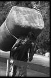 Laborer carrying a heavy burden in Simla, 1985